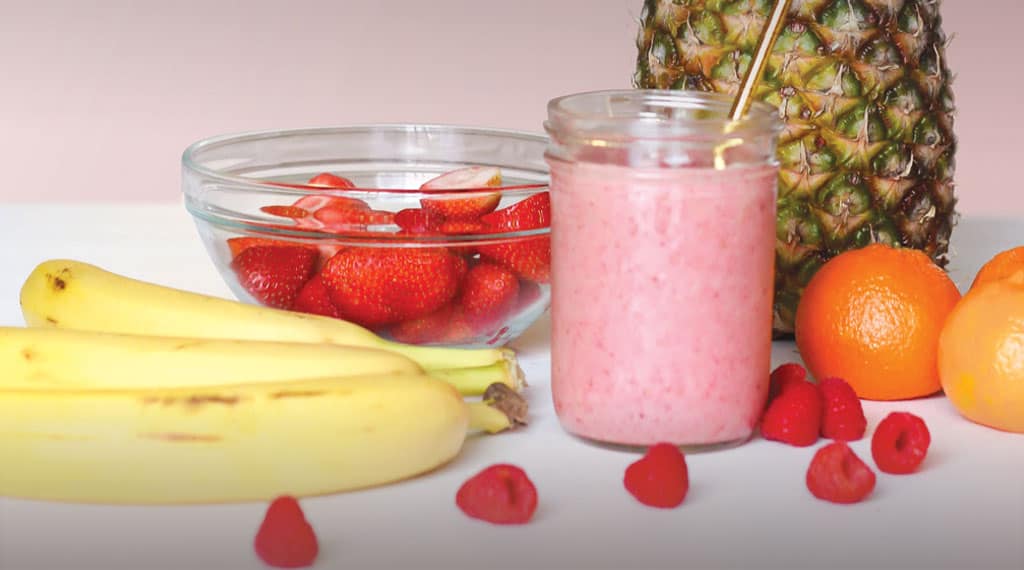 Fruit smoothie with bananas, strawberries, and oranges for a healthy lifestyle.